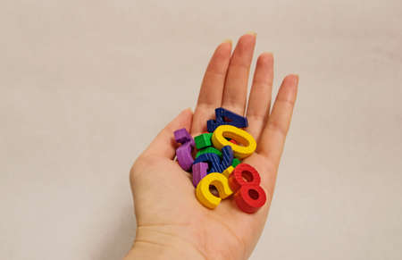 Multicolored bright children's numbers for development from zero to nine lie in a handful in the...