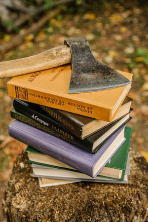 08/01/2021 Russia, Tula, an ax lies on a stack of books on a tree stumpのeditorial素材