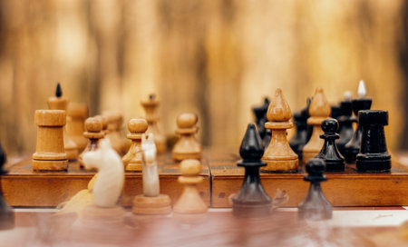 Chessboard in autumn leaves with spaced shapes with blur and bokeh effectの写真素材
