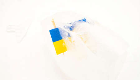 Ukrainian flag frozen in ice on a white background