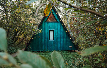 Autumn landscape of a house with garlands framed by grassの写真素材