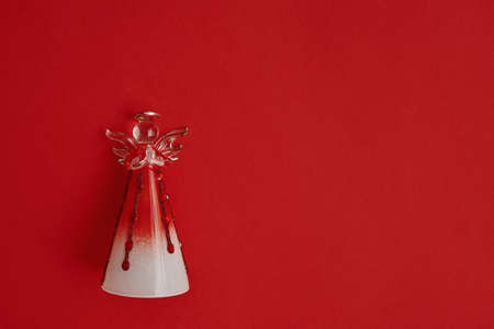 Christmas decoration angel on red background