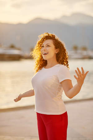 Woman singing on the beachの写真素材