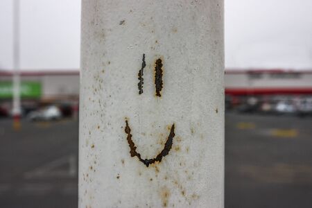 Metal texture with a happy face.の写真素材