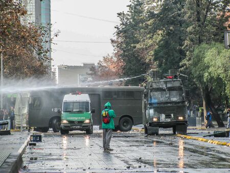 SANTIAGO, CHILE - 30 JUNE 2011: Student's March, police used water cannon against the student protesters in Chile.のeditorial素材
