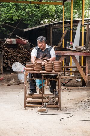 Pomaire, Chile - September 15, 2016: A potterer working his craftのeditorial素材