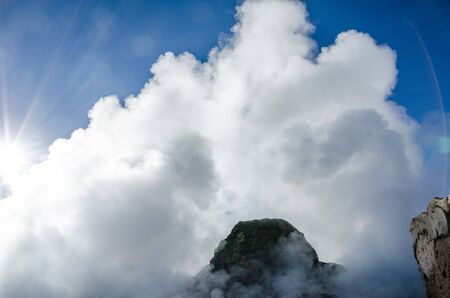 Blue sky with geyser steam and sun reflection in Tatio geysers, Atacama desert, Chile