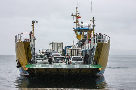 Pargua, Chile - February 16, 2012: Ferry onloading cars and passengers for crossing from the Chilean mainland to the Island of Chiloe.のeditorial素材