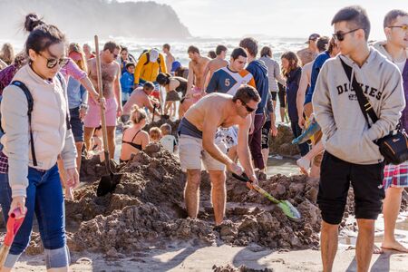 Coromandel Peninsula, New Zealand - June 04, 2017: Geothermal attractions in New Zealand, tourists making small hot water pools in Hot Water beach.のeditorial素材