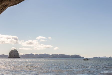 coromandel, New Zealand - June 04, 2017: Busy day at Cathedral Cove in Coromandel Peninsula on the North Island of New Zealand. Patrol boatのeditorial素材