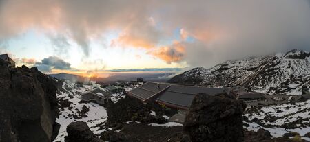 Whakapapa, New Zealand - August 11, 2018: A fiery sunset over the Top of the Bruce ski lodges, Whakapapa Skifield, New Zealand.のeditorial素材