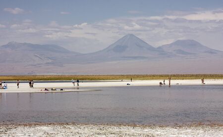 Atacama Desert, Chile - January 14, 2013: Tourists floating on a salt lake in Cejar Lagoon, Atacama Desert, Chileのeditorial素材