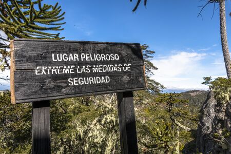 La Araucania Region, Chile - September 21, 2016: DANGEROUS PLACE, EXTREME SAFETY MEASURES Information sign in Nahuelbuta National Park, South of Chile.のeditorial素材