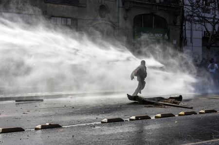 Santiago, Chile - July 14, 2011: Police use water cannons against protestors during a protest in Santiago, Chileのeditorial素材