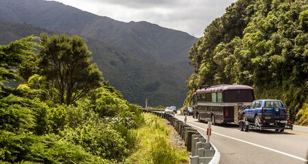 Pakuratahi Forest - New Zealand - March 03, 2018: Traffic on a cloudy day over the mountains in New...