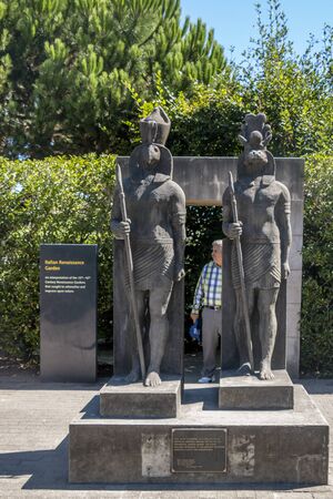 Hamilton, New Zealand - February 26, 2017: Person on the gate with sculptures on Hamilton Gardens,...