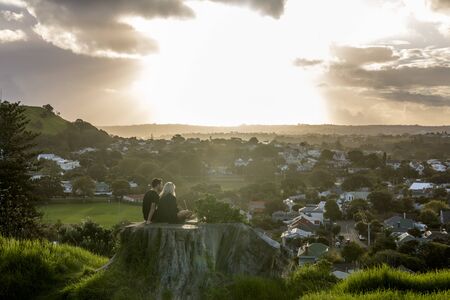 Auckland, New Zealand - April 16, 2017: Couple enjoying the sunset from North Head Devonport, New Zealand.のeditorial素材