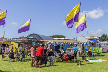 Whangamata, New Zealand - January 02, 2019: Tourists enjoying the live music and family...