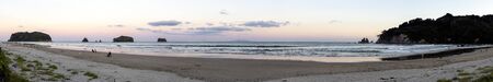 Whangamata, New Zealand - January 02, 2019: People enjoying a beautiful sunset at Whangamata beach, North Island, New Zealand.のeditorial素材