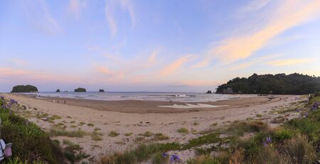 Whangamata, New Zealand - January 01, 2019: People enjoying a beautiful sunset at Whangamata beach, North Island, New Zealand.のeditorial素材