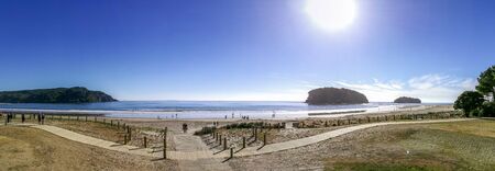People enjoying a sunny day in Whangamata beach, New Zealand.の写真素材