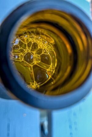 Beer bubbles inside a glass bottleの写真素材