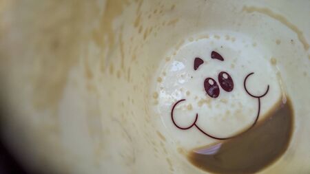 Happy face on the bottom of the coffee cupの写真素材