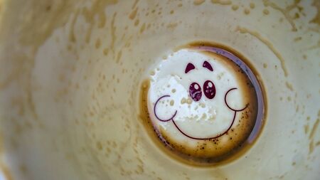 Happy face on the bottom of the coffee cup
