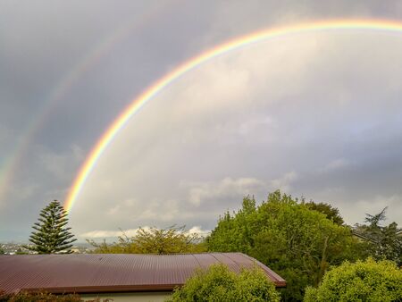 Rainbow view from the window in Browns Bay, Auckland, New Zealandの写真素材