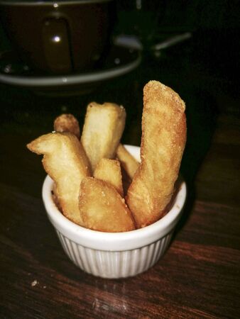 A small bowl of potatoes chipsの写真素材
