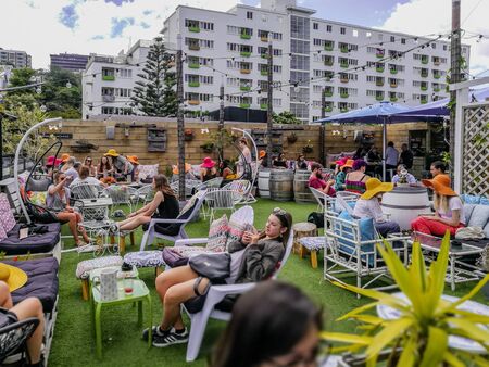 Wellington, New Zealand - November 17, 2017: People enjoying a beautiful sunny day at the Wellington Arborist Rooftop Bar in Wellington, New Zealand.のeditorial素材