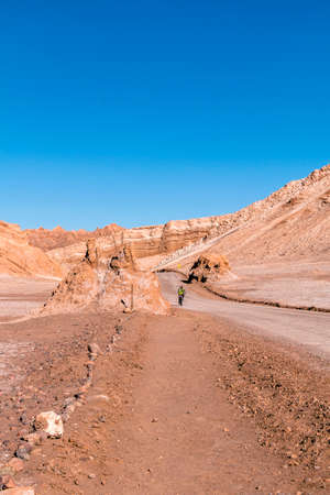 San Pedro De Atacama, Chile - September 29, 2016: Security guard on a bicycle in the Dunes of Moon Valley in Atacama Desert, Chile.のeditorial素材