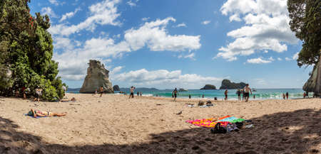 Coromandel, New Zealand - December 28, 2019: Busy day at Cathedral Cove in Coromandel Peninsula on the North Island of New Zealand. Tourists exploring around it.のeditorial素材