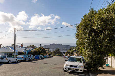 Wellington, New Zealand - August 06, 2018: Woman chasing away some pigeon stealing food from the table in Wellington CBD, New Zealandのeditorial素材