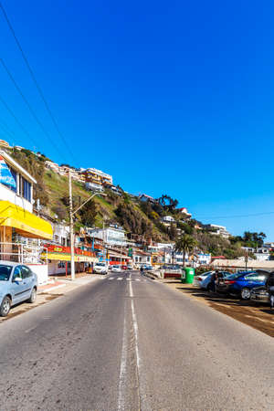 Concon, Chile - August 12, 2019: People enjoying at the large sand dunes on the coast of ConcÃ³n, Chile.のeditorial素材