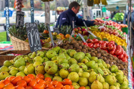 Santiago, Chile - September 10, 2017: Saleswoman posing next to her fruits on sale at the market of...