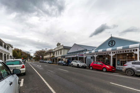 Martinborough, New Zealand - May 29, 2021: Bicycles, car, and an old racing car on the parking of...