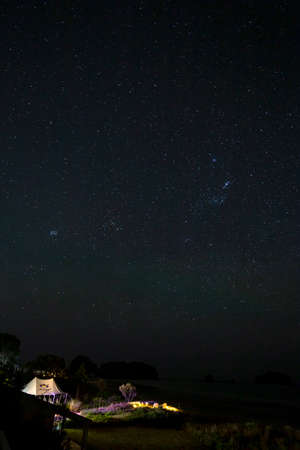 Whangatama, New Zealand - November 23, 2019: Beautiful star trails light up the night sky of...