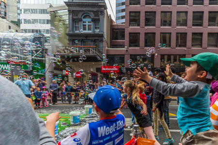 Wellington, New Zealand - November 25, 2018: Bubble maker blowing giant bubbles at Wellington Santa Parade, "A Very Welly Christmas", on Lambton Quay, New Zealand.のeditorial素材