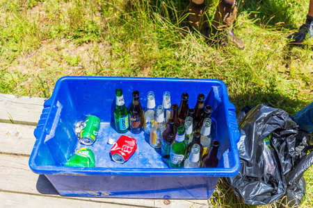 Waikato, New Zealand - December 25, 2021: Recycling bottles and can on a blue containerのeditorial素材