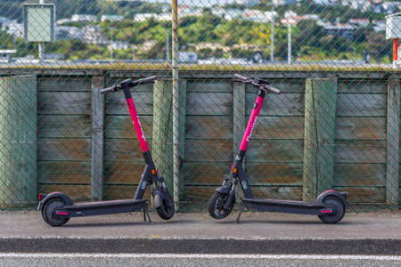 Wellington, New Zealand - September 18, 2022: Two Flamingo electric scooters on the pavement of Wellington, New Zealandのeditorial素材