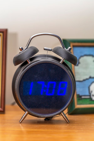 Digital alarm clock on wooden tableの写真素材