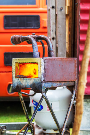 Whangamata, New Zealand - January 03, 2023: Behold the fiery prowess of the industrial machine as it transforms raw metal into a world of possibilitie at The Original Gypsy Fair in Whangamata, New Zealandのeditorial素材