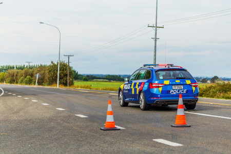 Rongotea, New Zealand - December 22, 2023: Law enforcement in action, a police car strategically blocks and redirects traffic on the motorway, ensuring public safety and maintaining order during a critical situation.のeditorial素材