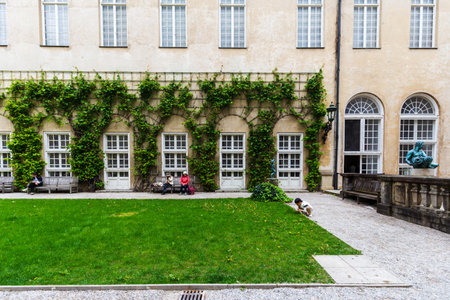 Munich, Germany - May 09, 2024: Historic Ivy-Covered Window and Bench at Munich Residenzmuseumのeditorial素材