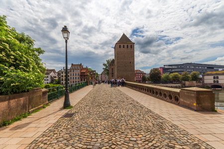 Strasbourg, France - May 13, 2024: Scenic Bridge with Historic Tower in Petite-France Strasbourgのeditorial素材