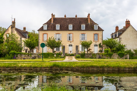 Nemours, France - May 18, 2024: Elegant French Manor House by the Canal in Nemours, France