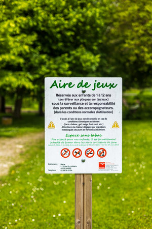Nargis, France - May 26, 2024: A detailed playground safety sign in a lush green park in Nargis, France, providing important rules and regulations for safe playのeditorial素材