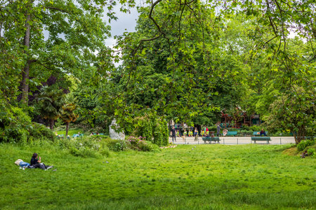 Paris, France - May 27, 2024: A serene scene at Parc Monceau, Paris, where visitors relax and enjoy the lush greenery and vibrant atmosphere of this beautiful urban parkのeditorial素材
