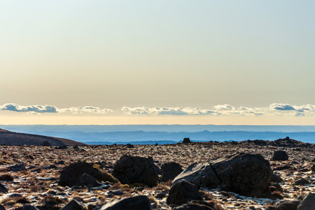 A tranquil scene at sunset over rocky terrain in New Zealandの写真素材